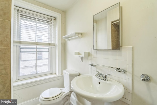 bathroom featuring sink, decorative backsplash, toilet, and a healthy amount of sunlight