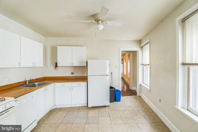 kitchen featuring white cabinetry, sink, white appliances, and a healthy amount of sunlight