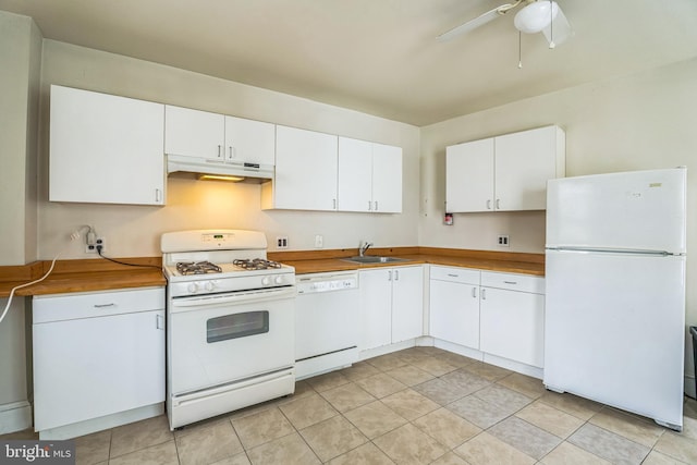 kitchen featuring sink, white appliances, ceiling fan, white cabinets, and light tile patterned flooring