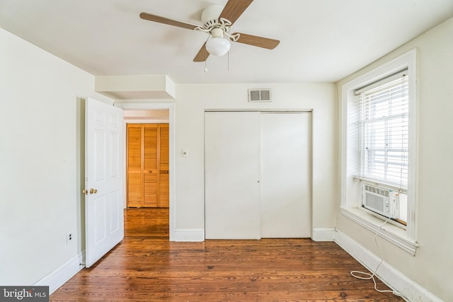 unfurnished bedroom featuring ceiling fan and dark hardwood / wood-style flooring