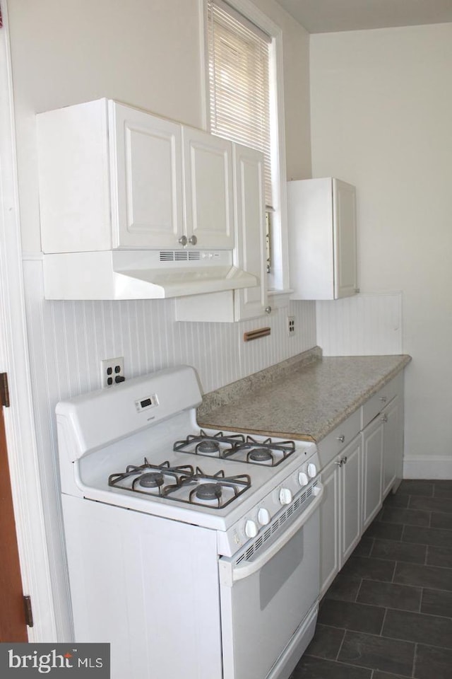 kitchen with white cabinets and white range with gas stovetop