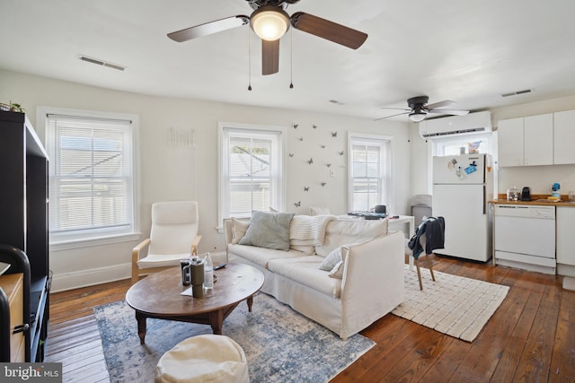 living room featuring dark hardwood / wood-style flooring and a wall unit AC