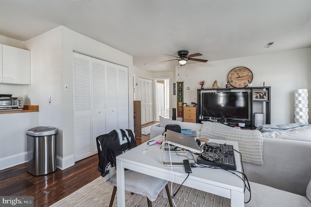 dining space with hardwood / wood-style floors and ceiling fan