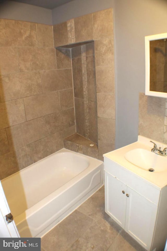 bathroom featuring vanity, tile patterned floors, and shower / washtub combination