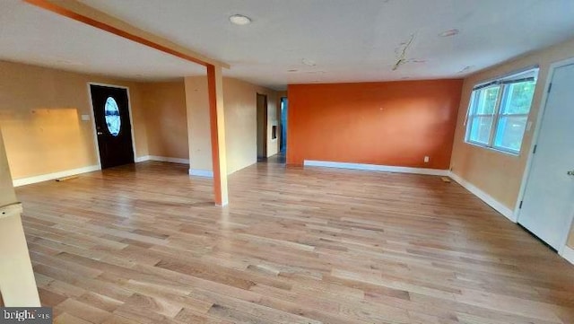 spare room featuring a wealth of natural light and light hardwood / wood-style flooring