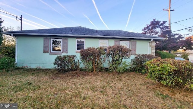 view of side of home featuring a yard