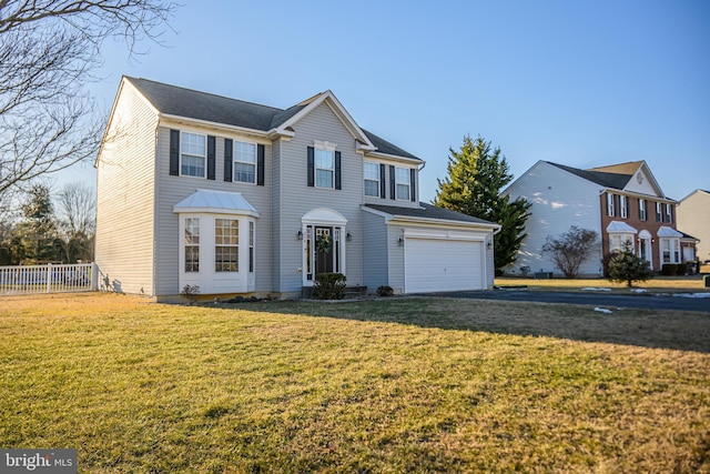 view of front of house featuring a garage and a front lawn