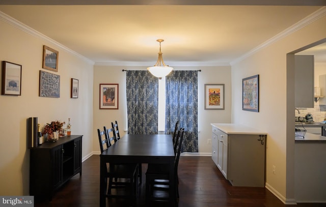 dining room with ornamental molding and dark hardwood / wood-style flooring