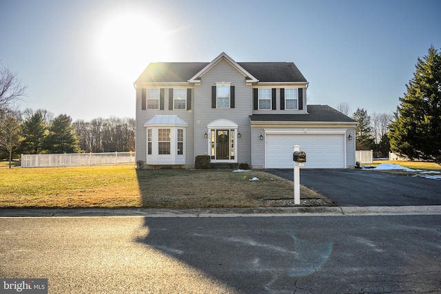 view of front of home with a garage and a front lawn