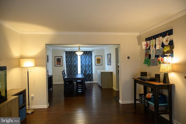 dining area with crown molding and dark hardwood / wood-style flooring