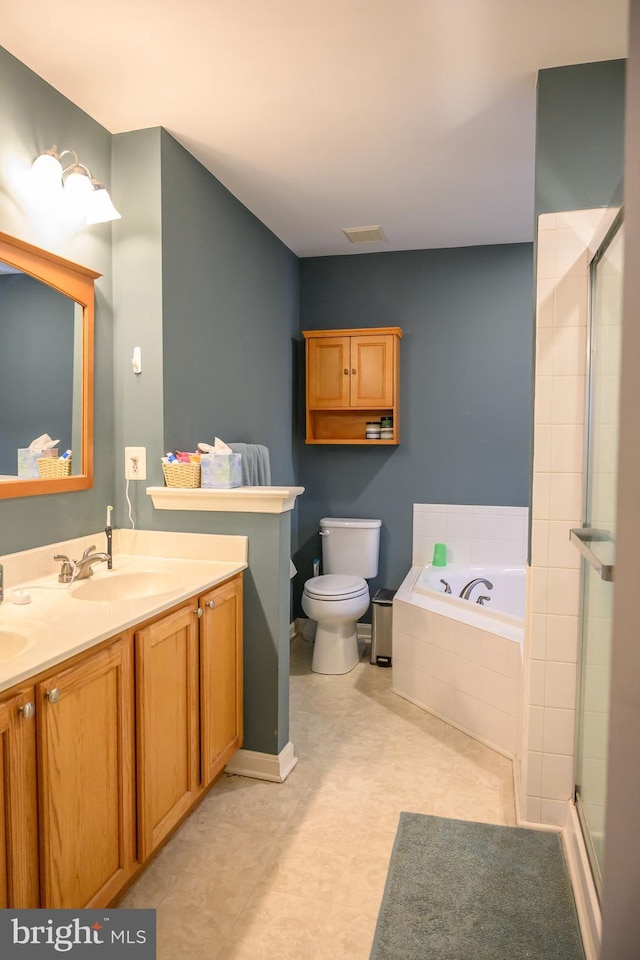 full bathroom featuring vanity, toilet, and separate shower and tub