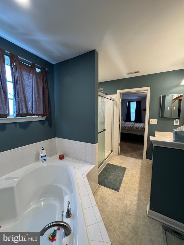 bathroom featuring vanity and shower with separate bathtub