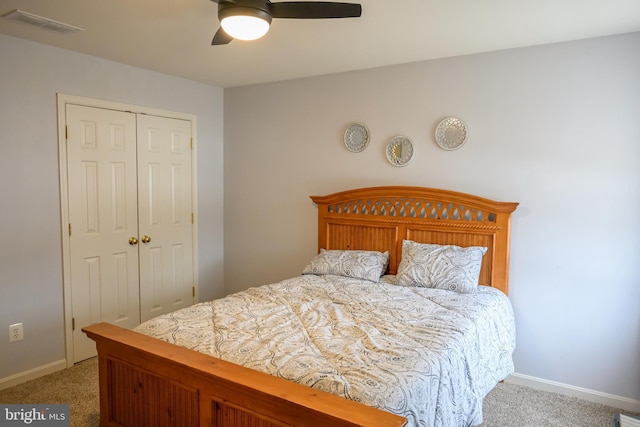 bedroom with light carpet, a closet, and ceiling fan