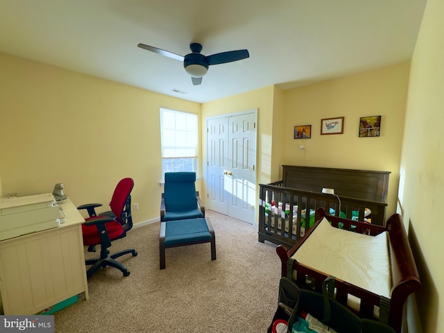 bedroom featuring a closet, ceiling fan, and carpet