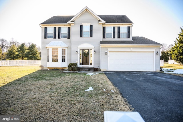 view of front of property with a garage and a front lawn