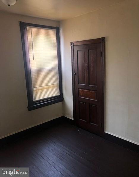 empty room featuring dark hardwood / wood-style floors