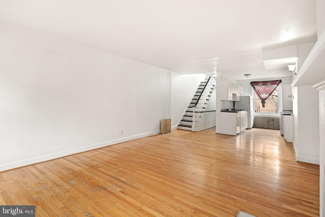 unfurnished living room featuring light hardwood / wood-style floors