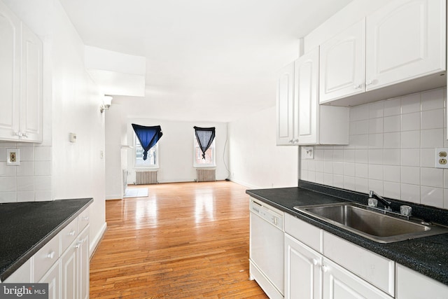 kitchen featuring sink, light wood-type flooring, radiator, dishwasher, and white cabinets