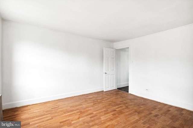 unfurnished room with hardwood / wood-style flooring