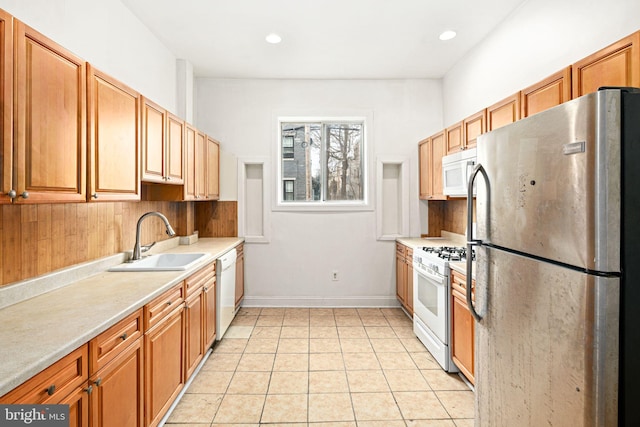 kitchen featuring light tile patterned flooring, sink, white appliances, and decorative backsplash