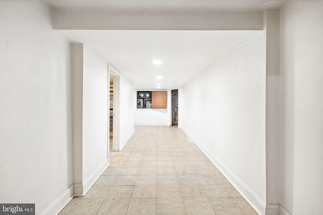 hall with light tile patterned floors