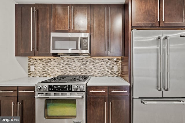 kitchen with tasteful backsplash, appliances with stainless steel finishes, and dark brown cabinetry