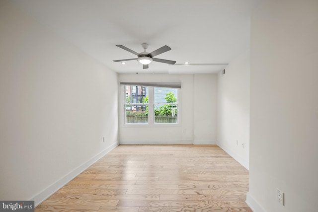 empty room featuring ceiling fan and light hardwood / wood-style flooring