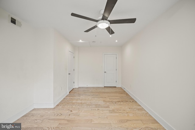 empty room featuring ceiling fan and light wood-type flooring