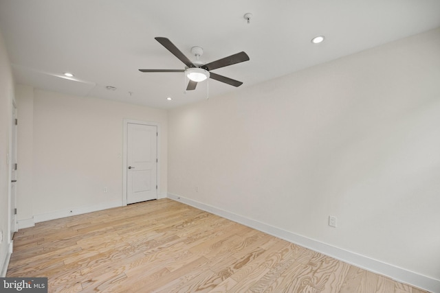 empty room featuring ceiling fan and light hardwood / wood-style floors