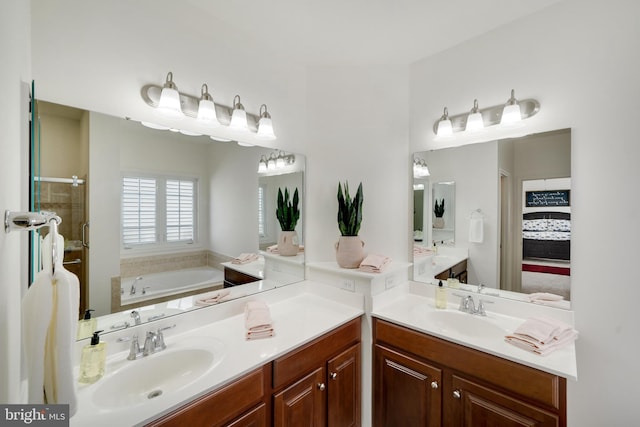 bathroom with vanity and separate shower and tub