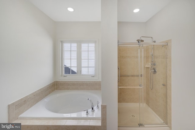 bathroom with shower with separate bathtub