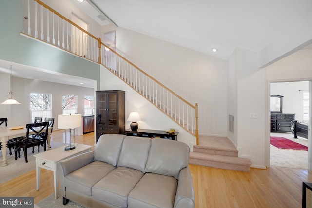 living room featuring a high ceiling and hardwood / wood-style floors