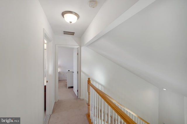 hallway featuring light colored carpet