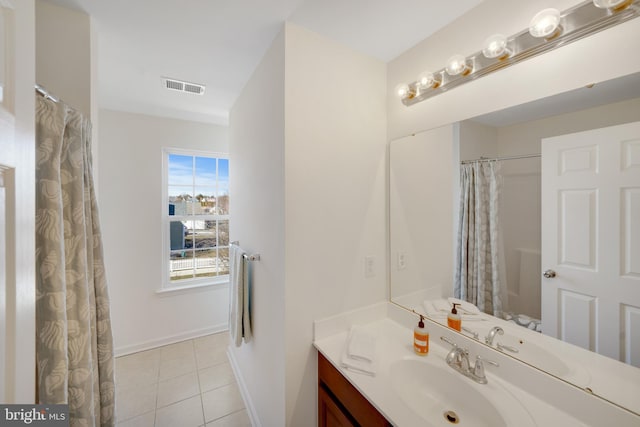 bathroom featuring tile patterned flooring and vanity