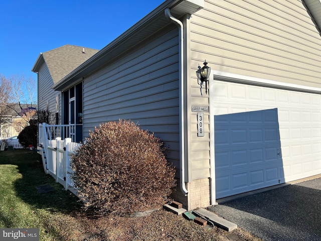 view of side of home featuring a garage