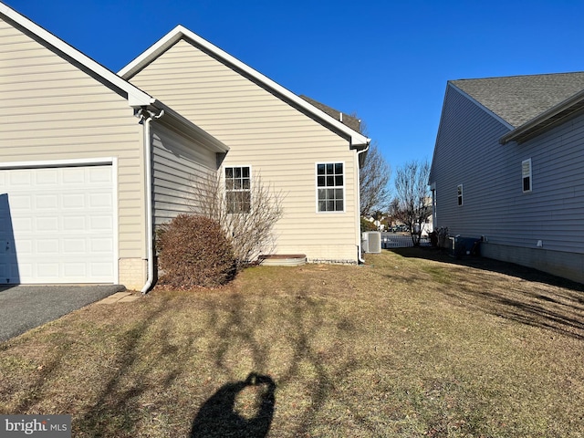 view of home's exterior with central AC and a lawn