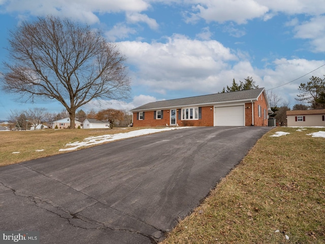 view of front of home with a garage and a front yard