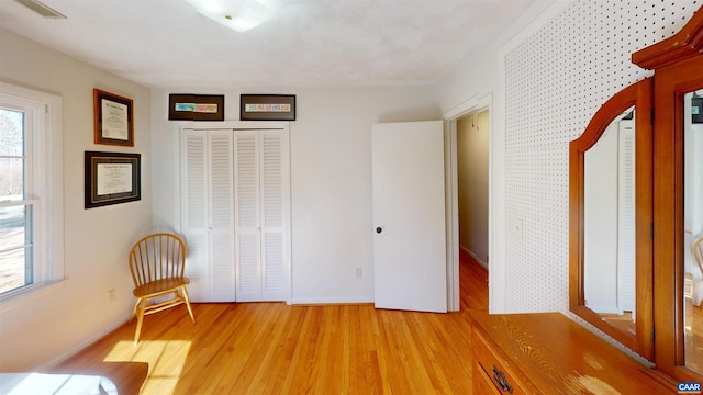 unfurnished room with a wealth of natural light and light hardwood / wood-style flooring