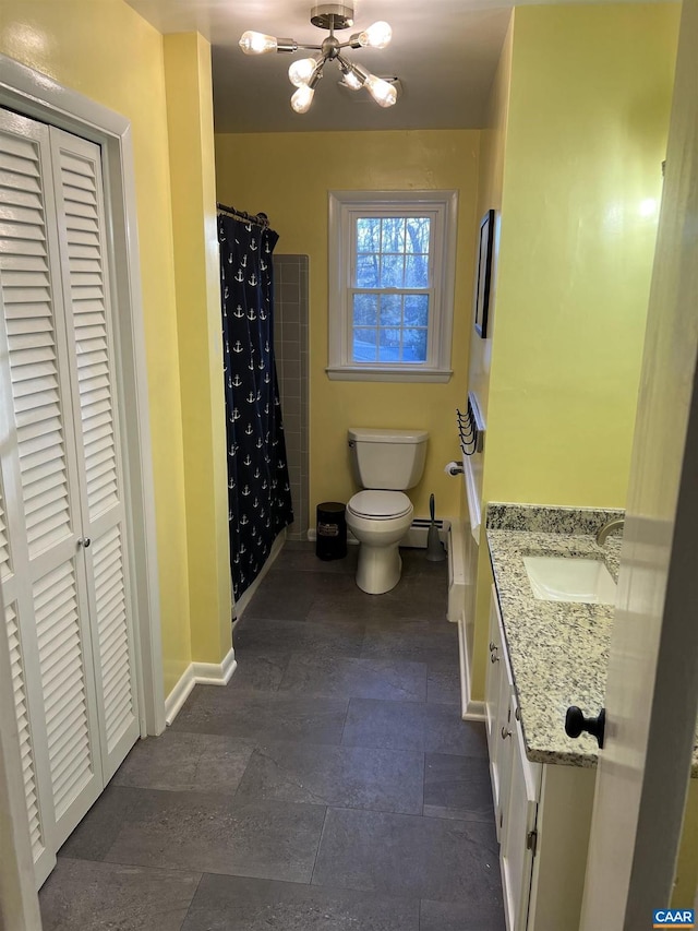 bathroom with vanity, curtained shower, baseboard heating, and toilet