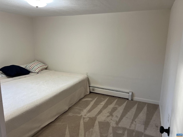 bedroom with carpet floors and baseboard heating