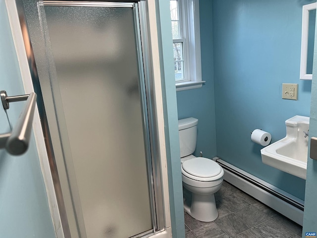 bathroom with toilet, baseboard heating, and a shower with shower door