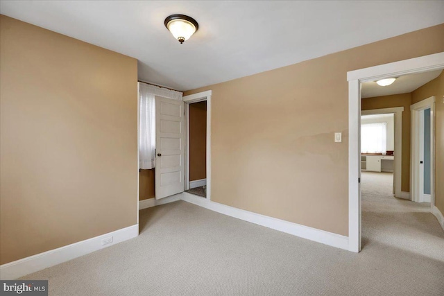 unfurnished bedroom featuring light carpet