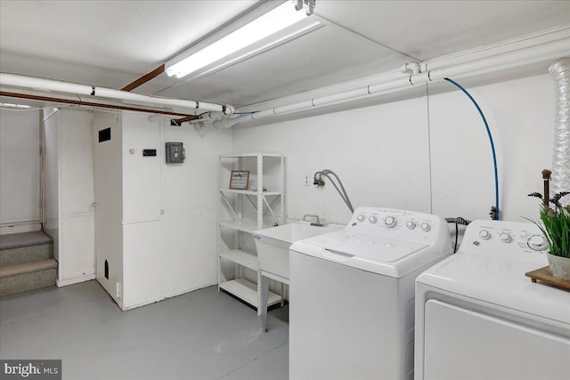 laundry room featuring sink and washer and dryer