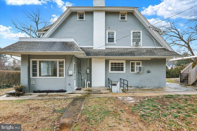 rear view of house featuring cooling unit