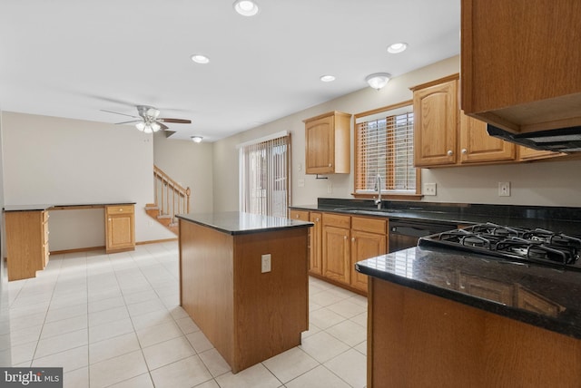 kitchen featuring sink, a center island, dishwasher, ceiling fan, and dark stone counters