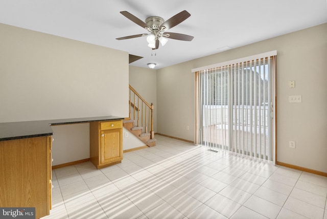 interior space with ceiling fan