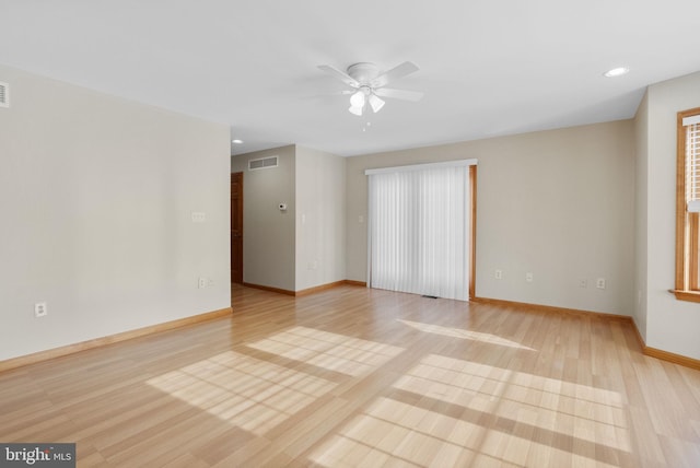 spare room featuring ceiling fan and light hardwood / wood-style floors