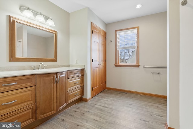 bathroom with vanity and hardwood / wood-style floors