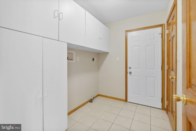 clothes washing area featuring washer hookup, cabinets, light tile patterned floors, and hookup for an electric dryer