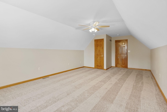 bonus room featuring light carpet, vaulted ceiling, and ceiling fan